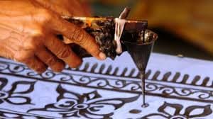 Tourists watching batik demo